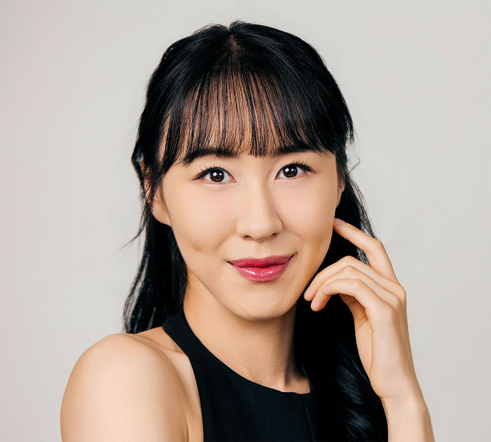 woman touching face smiling
