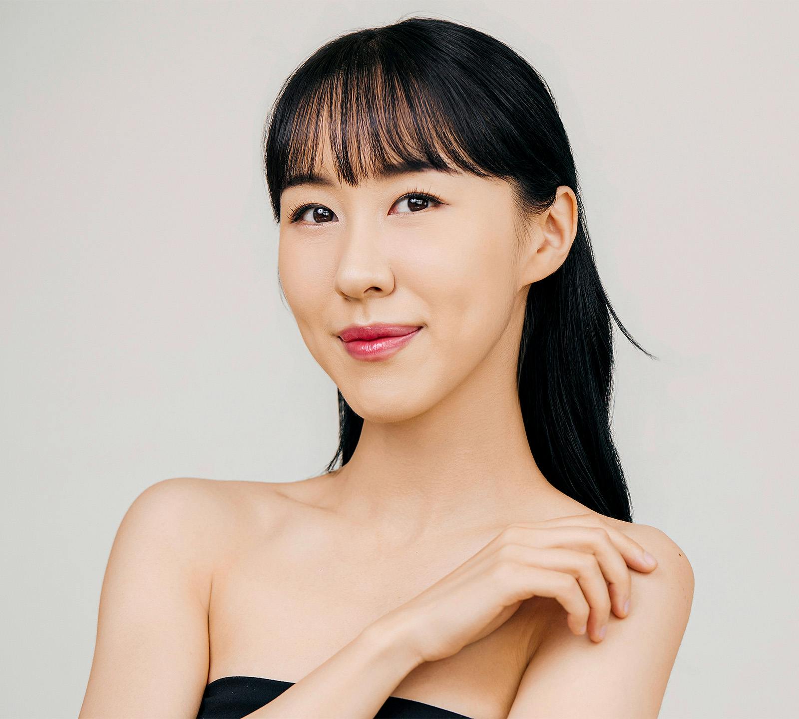 woman smiling touching shoulder