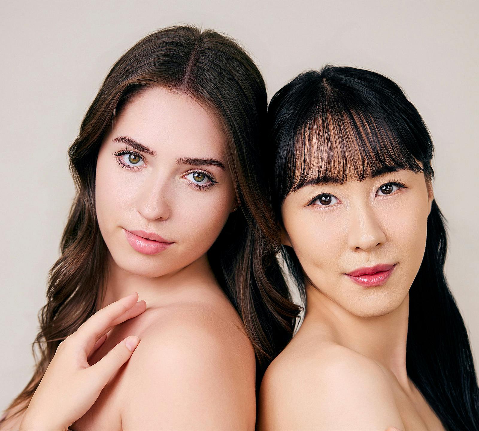 two girls leaning against eachother