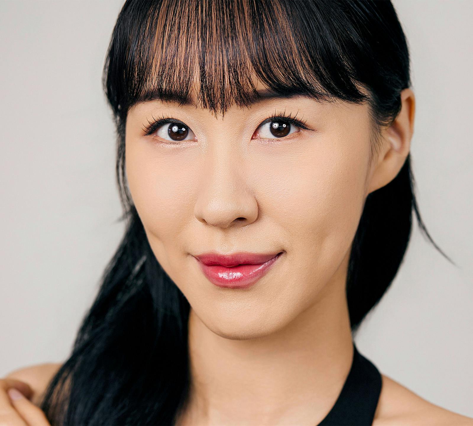 close up of womans face with a soft smile