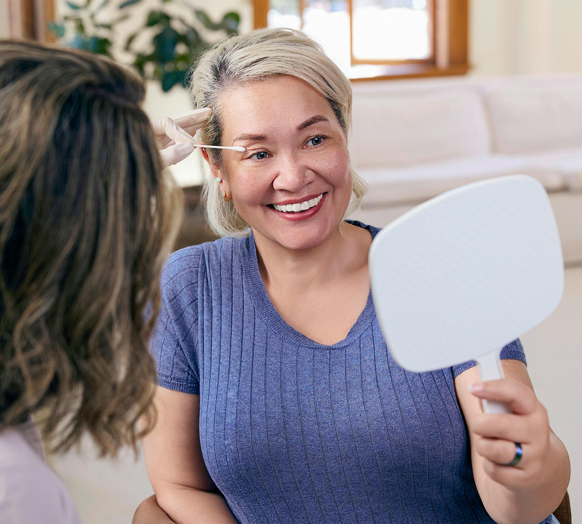 woman looking in mirror