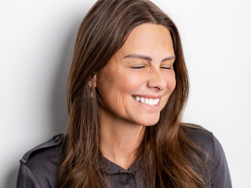 Woman smiling with her eyes closed