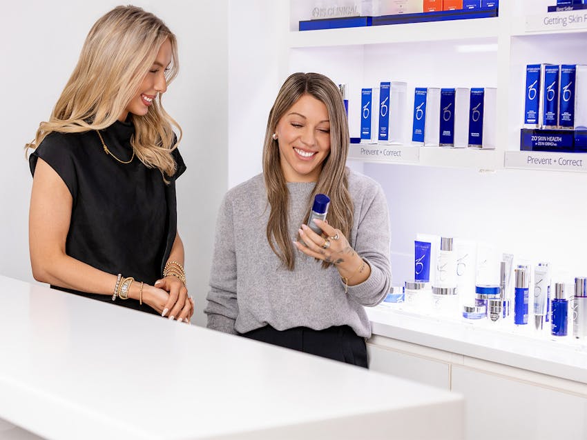 Two women looking at skin care