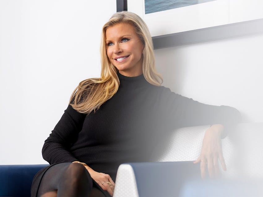 Woman sitting in a chair and smiling
