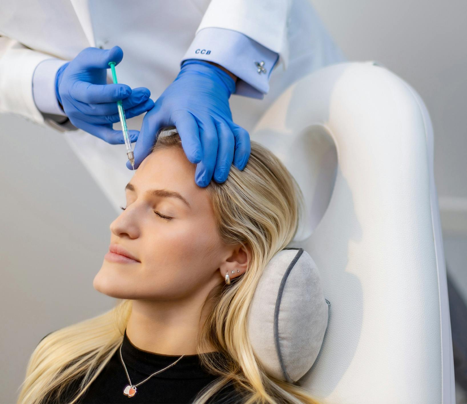 Woman getting botox in her forehead