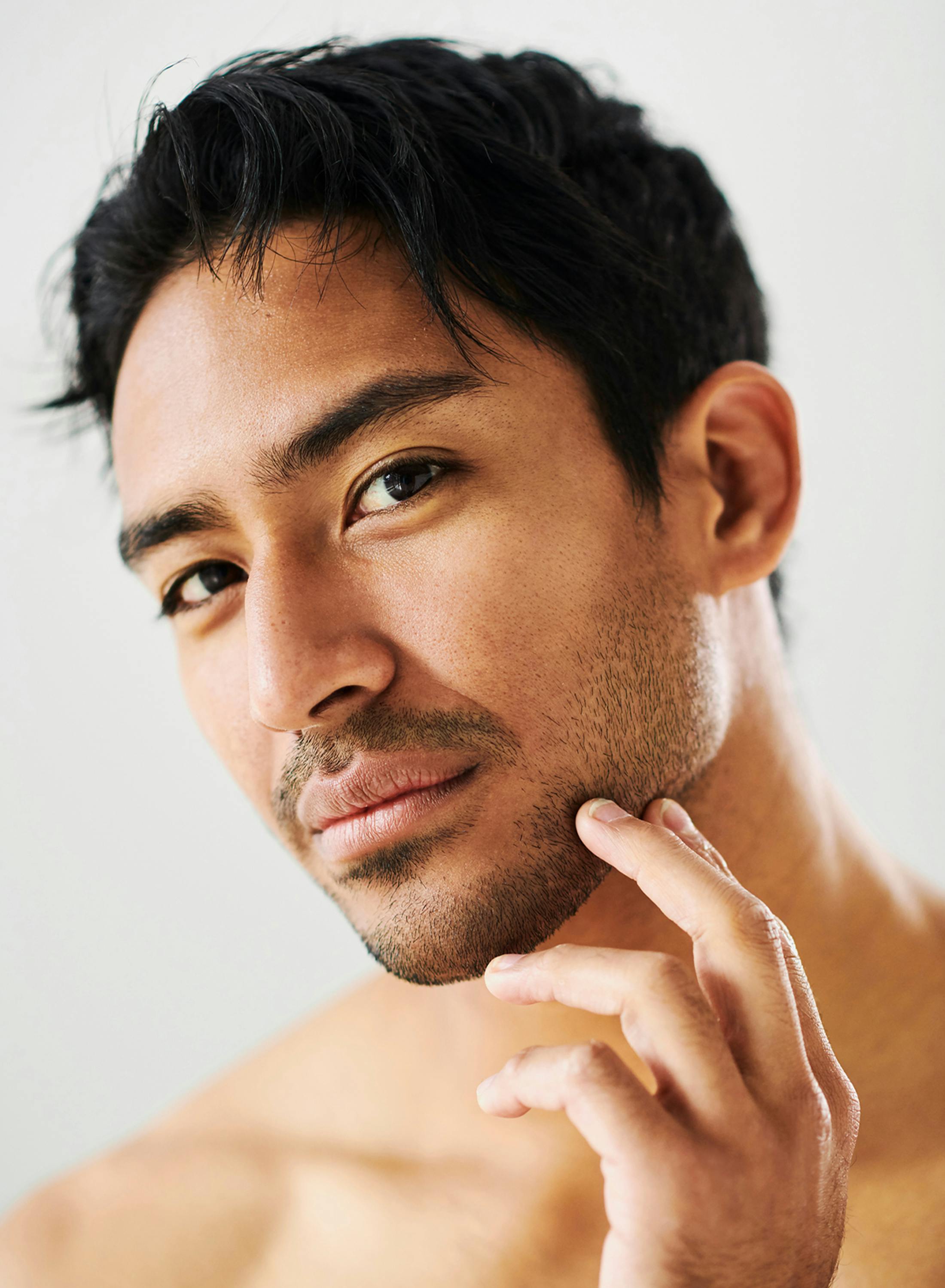 man touching his jaw