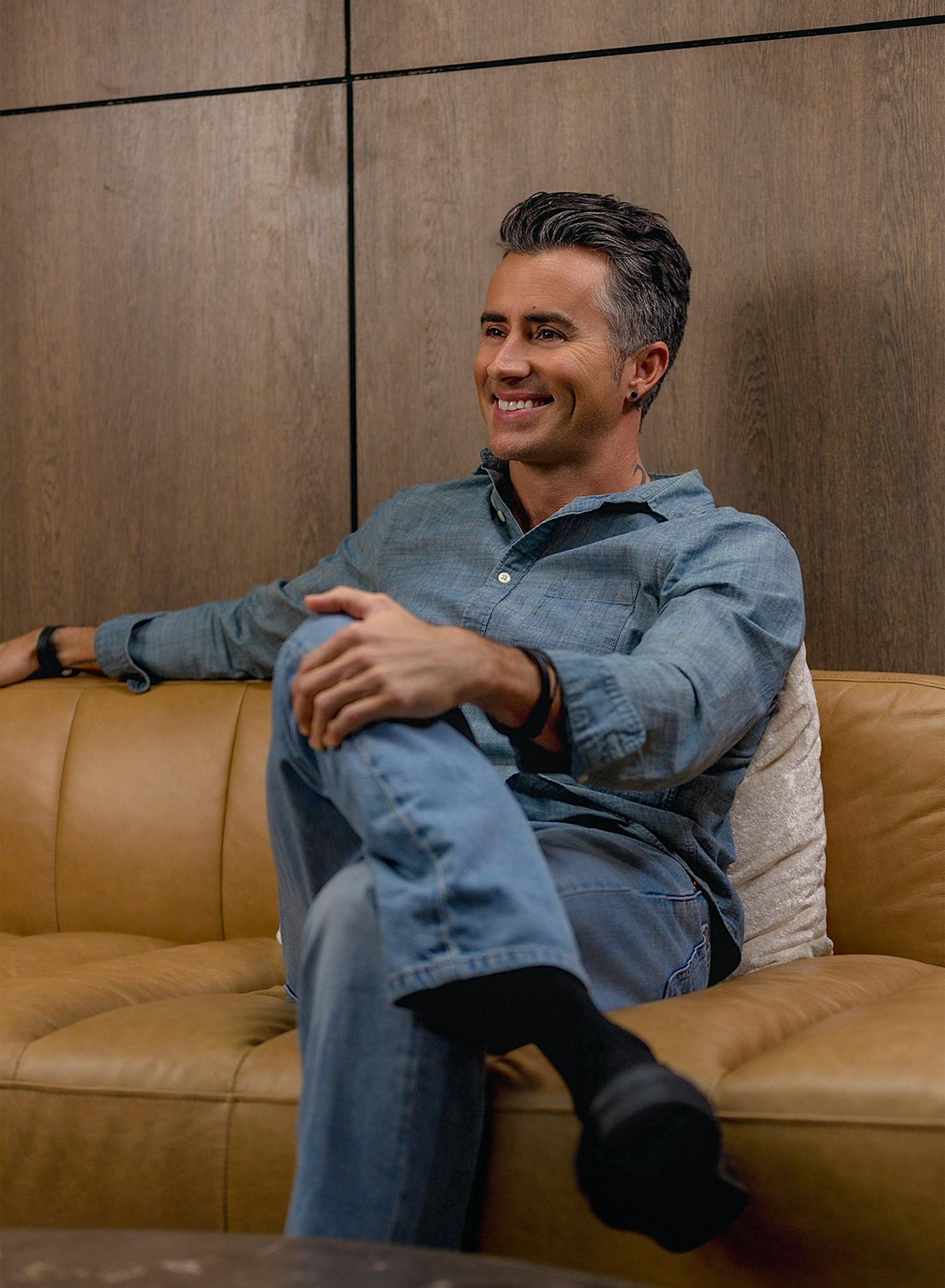 man sitting on sofa