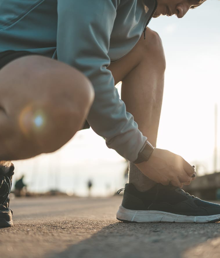man tying sneakers