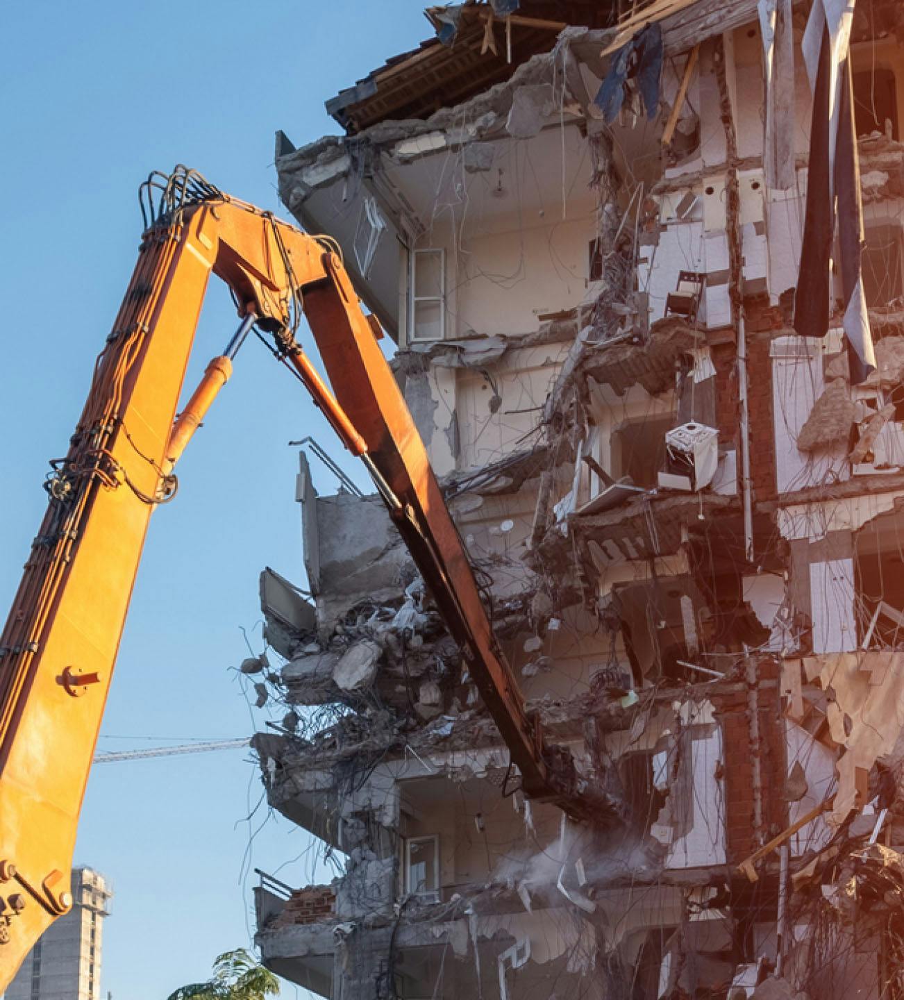 Crane knocking down a building
