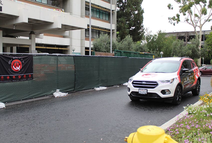 a car next to a fence