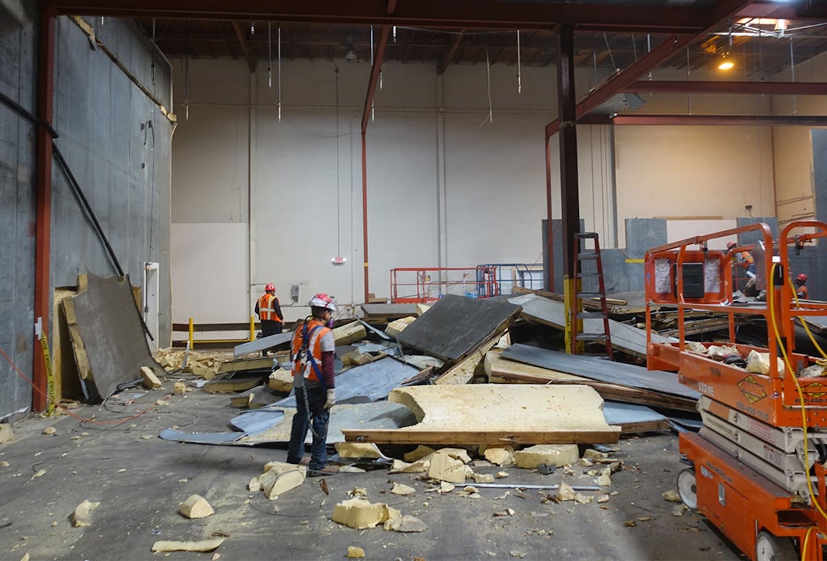 workers standing around debris