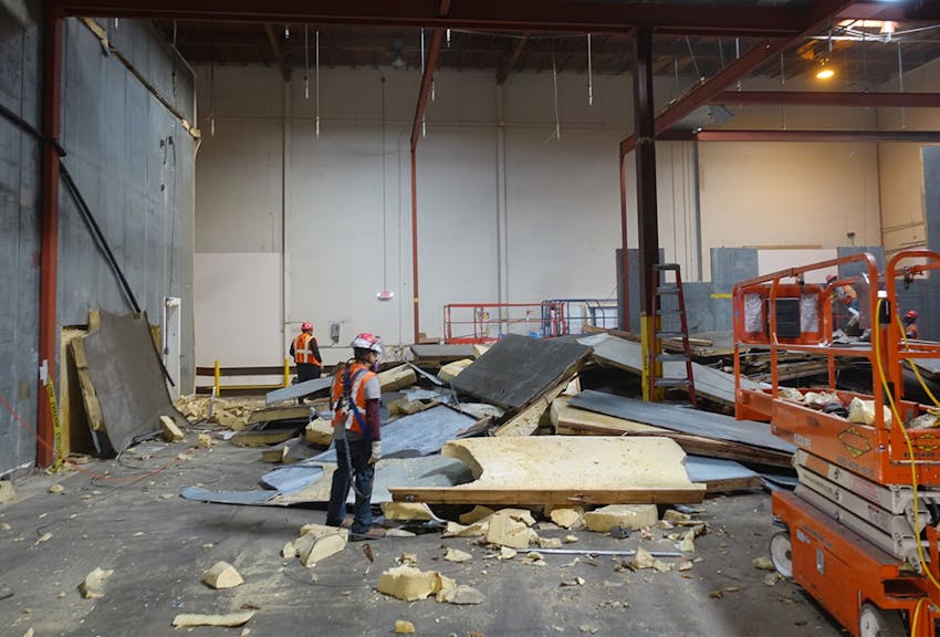workers standing around debris