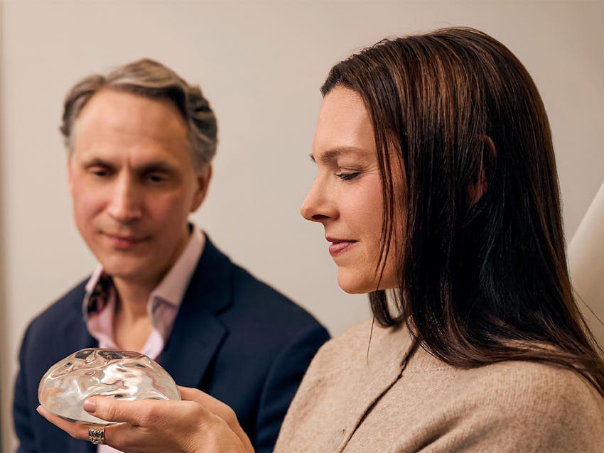 Woman and doctor looking at implants