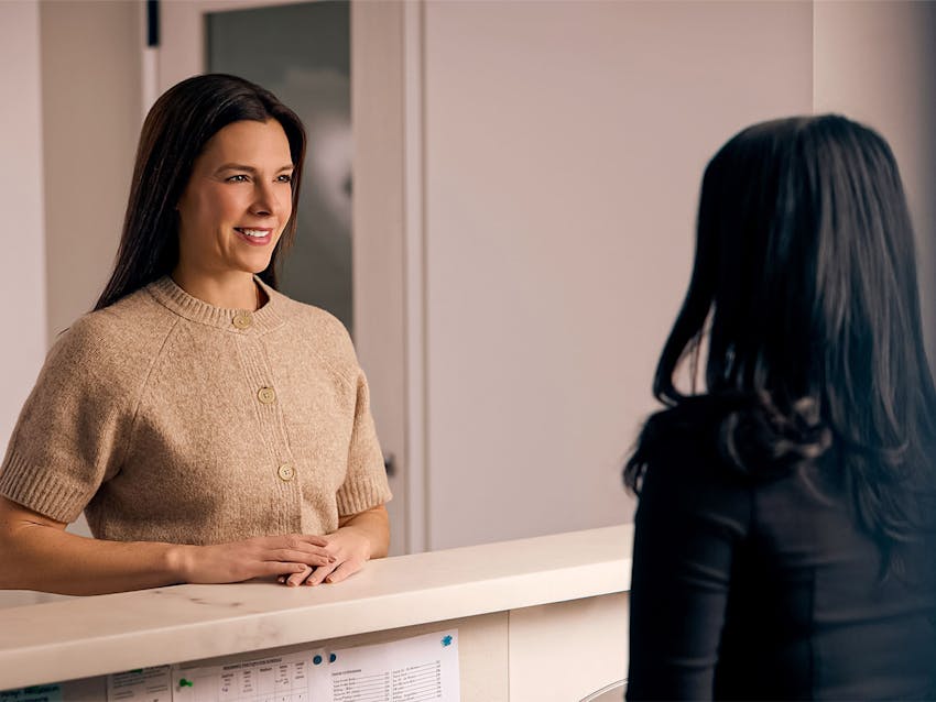 Woman speaking with front desk