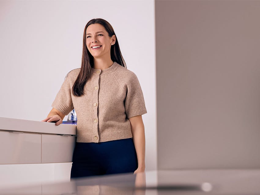 Woman smiling at a counter