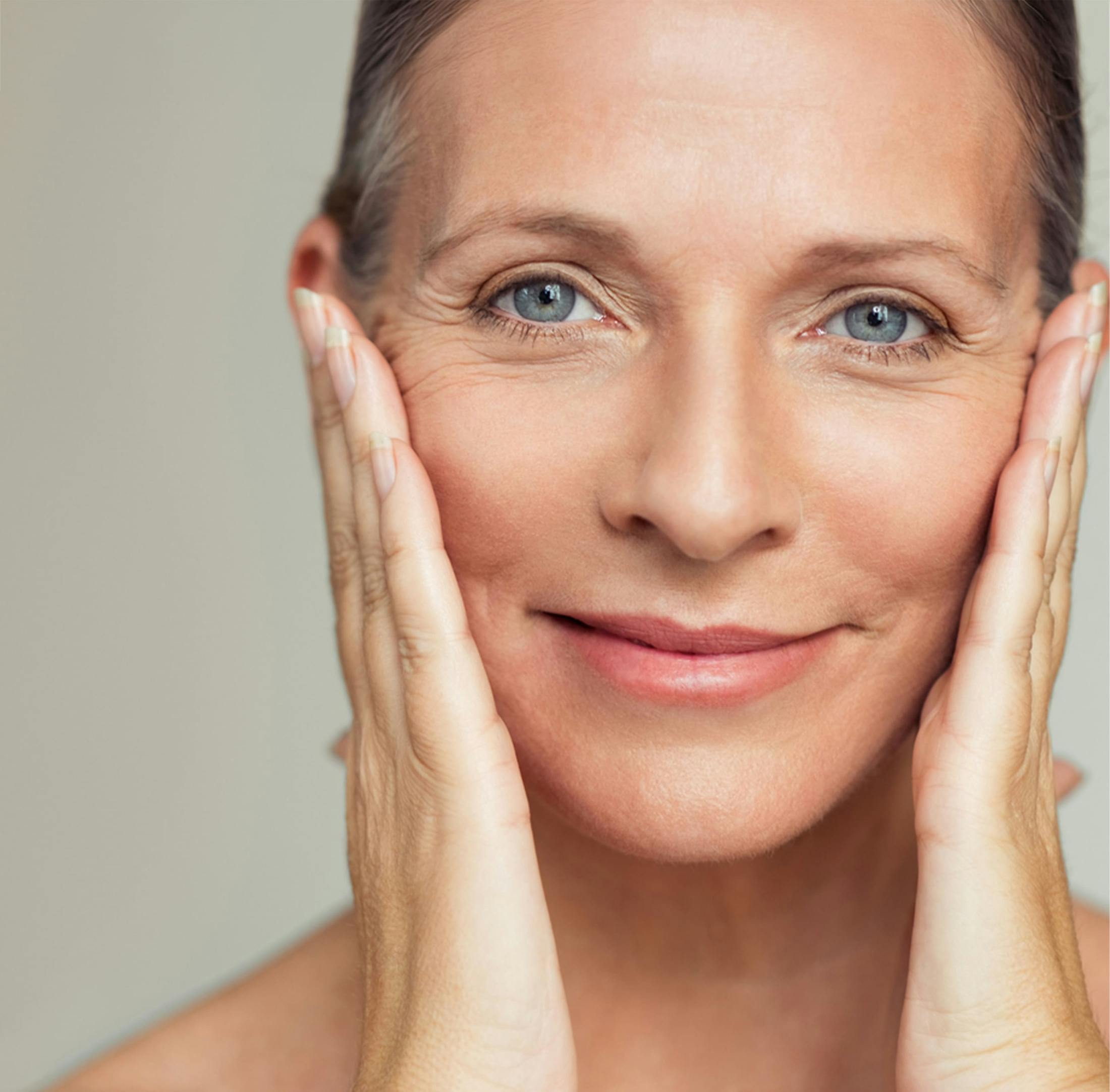Woman smiling with her hands on her cheeks