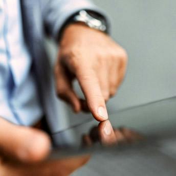 person's fingers on ipad