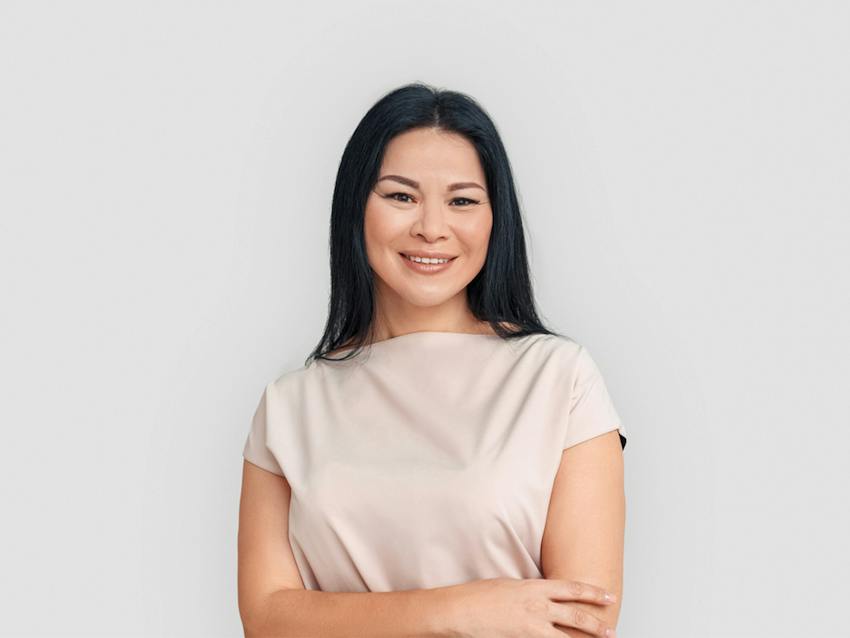 woman smiling with arms crossed