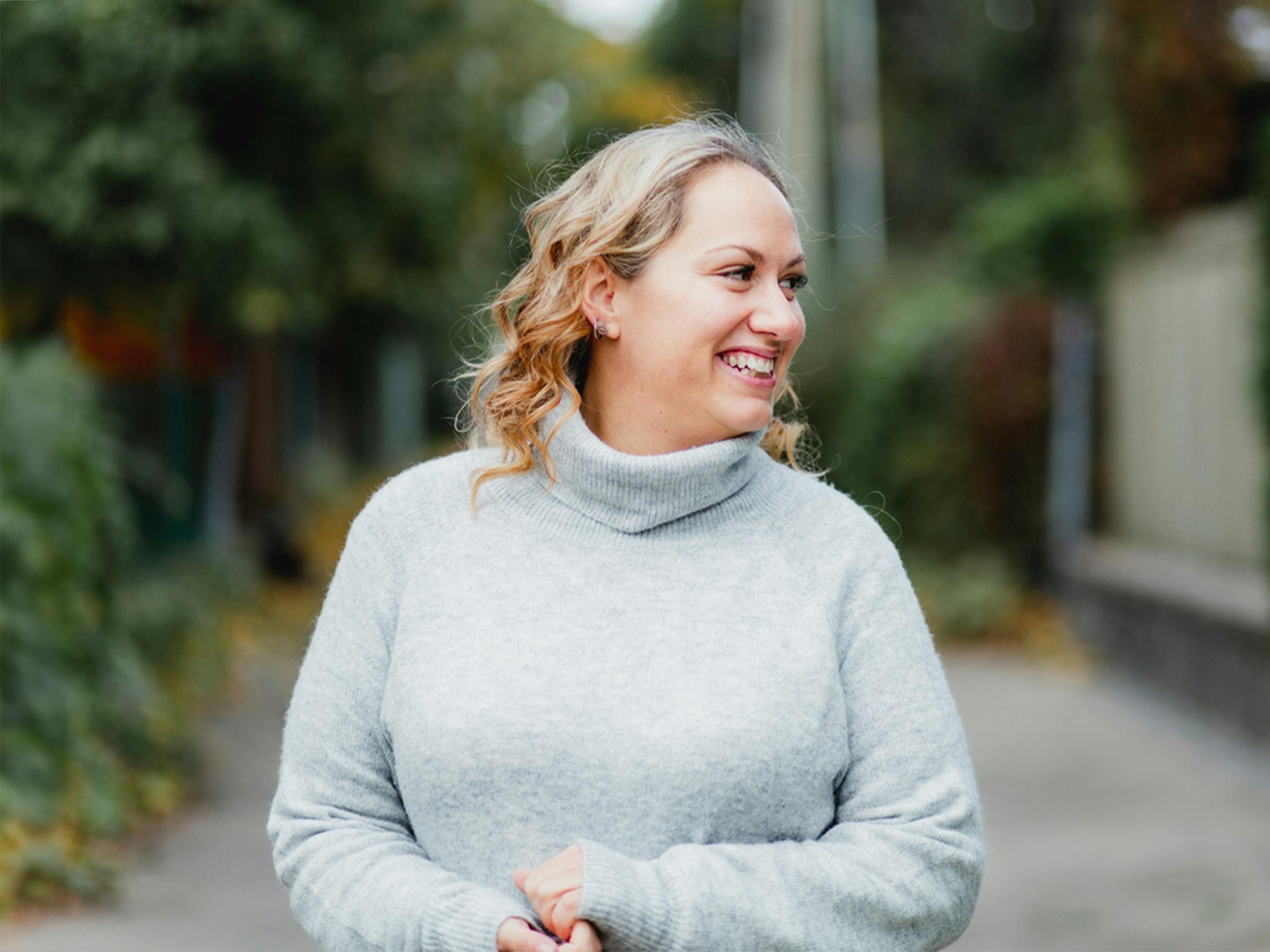 woman in sweater smiling