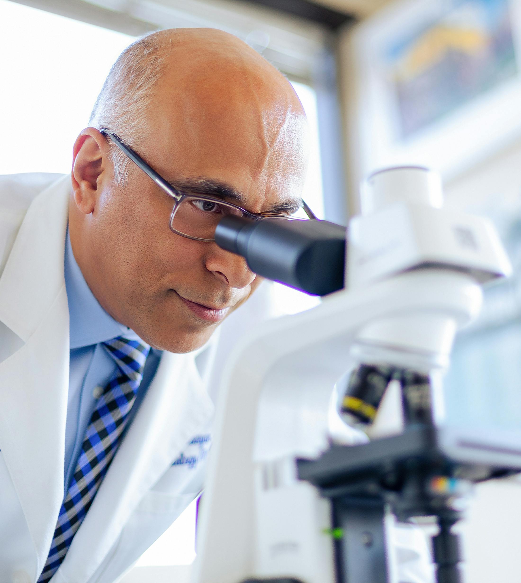 doctor looking in magnifying scope