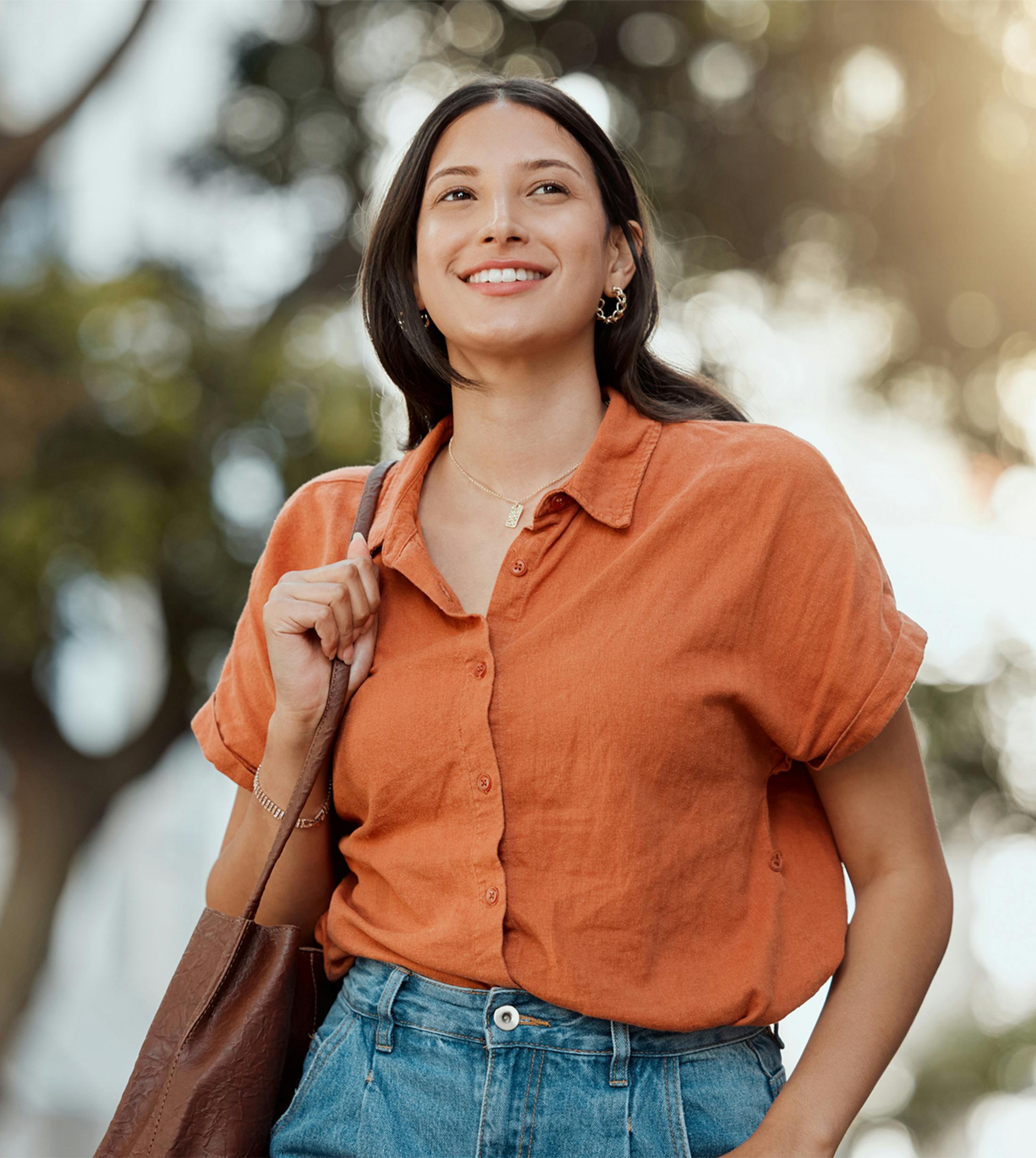 woman outside walking and smiling