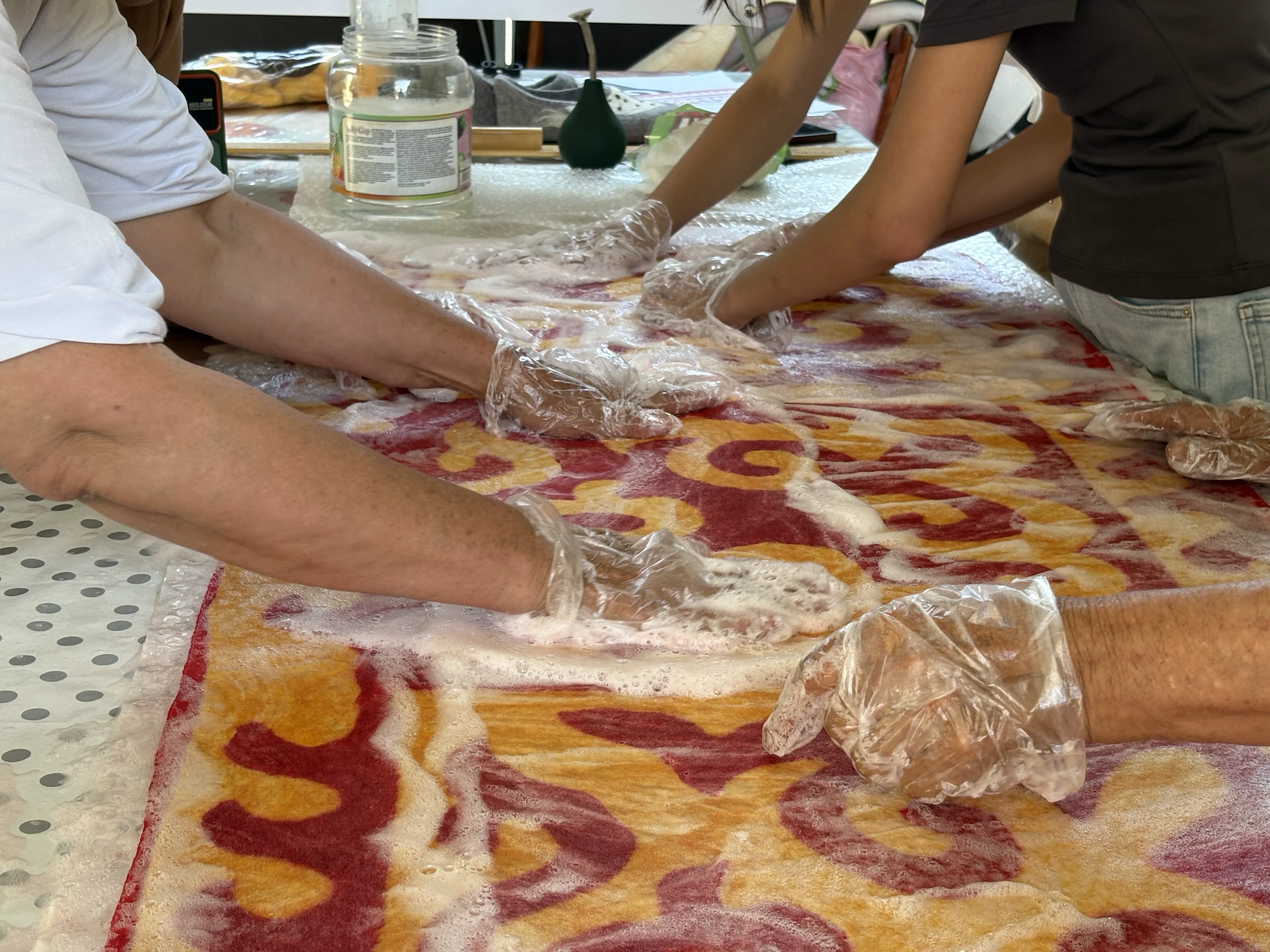 Rubbing the pattern into the cloth, close up
