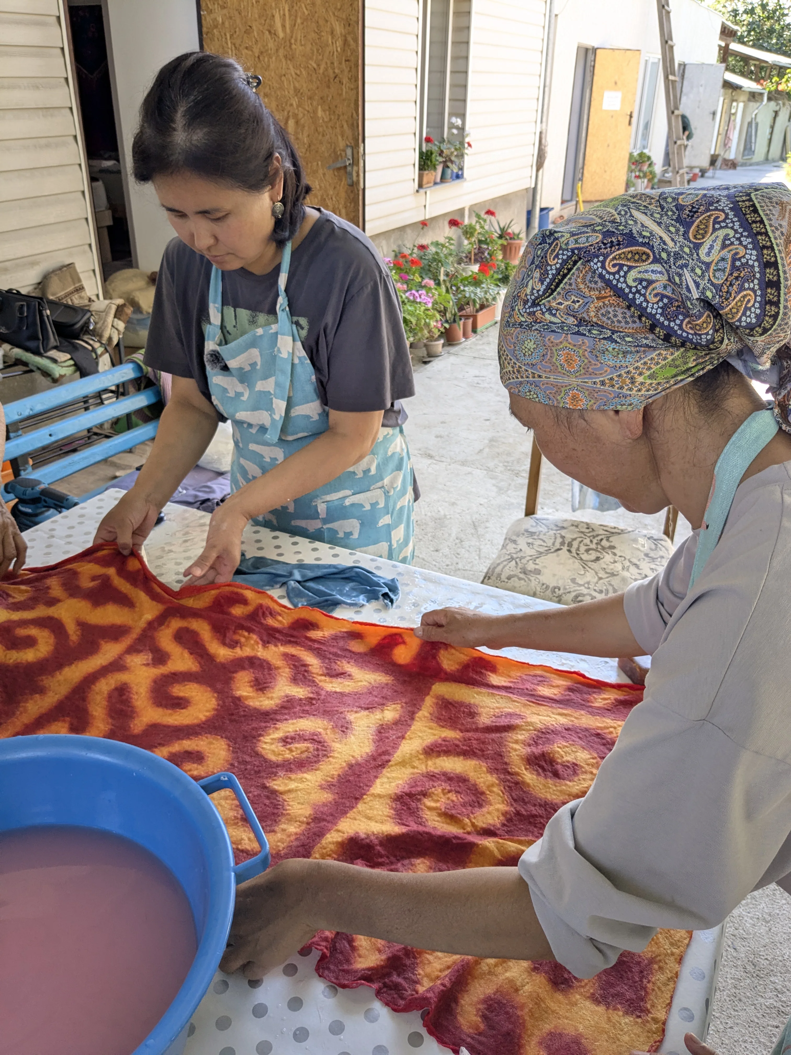 Rinsing the finished felt cloth with its pattern