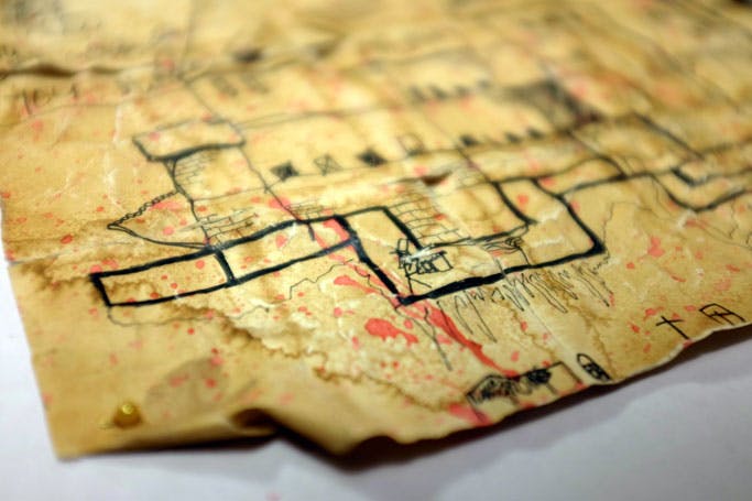Old stained parchment, torn and bloodied