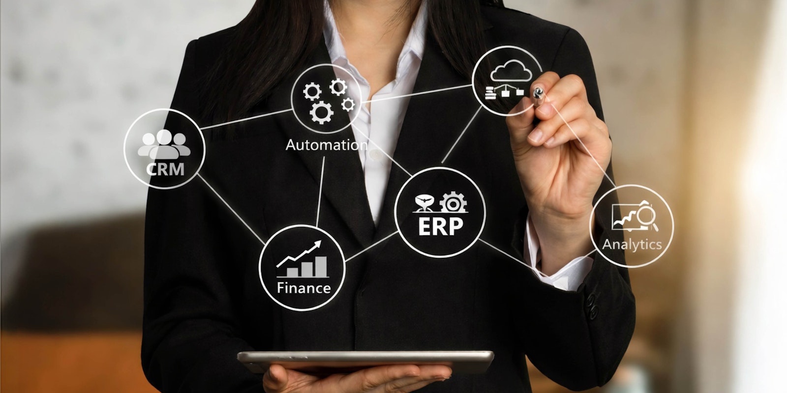 Woman holding a tablet with floating software integration icons representing connected IT systems and automated workflows
