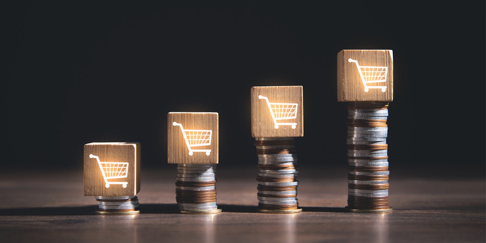 Increasing stacks of coins with shopping cart icons representing growth, scalability, and connected 3PL operations through iPaaS integrations