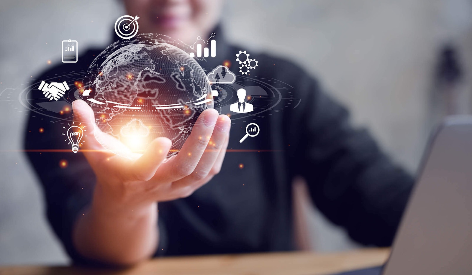 Graphic of a person holding a transparent tech globe with connected business icons, symbolizing flexible integrations and unique automation tools for developers.