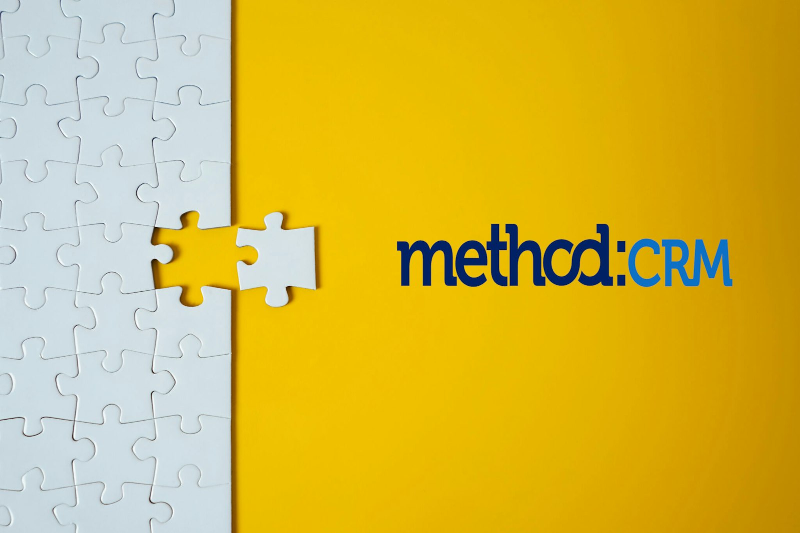 Graphic with a yellow background featuring white puzzle pieces on the left and the Method:CRM logo on the right, representing CRM integrations and connected business systems.