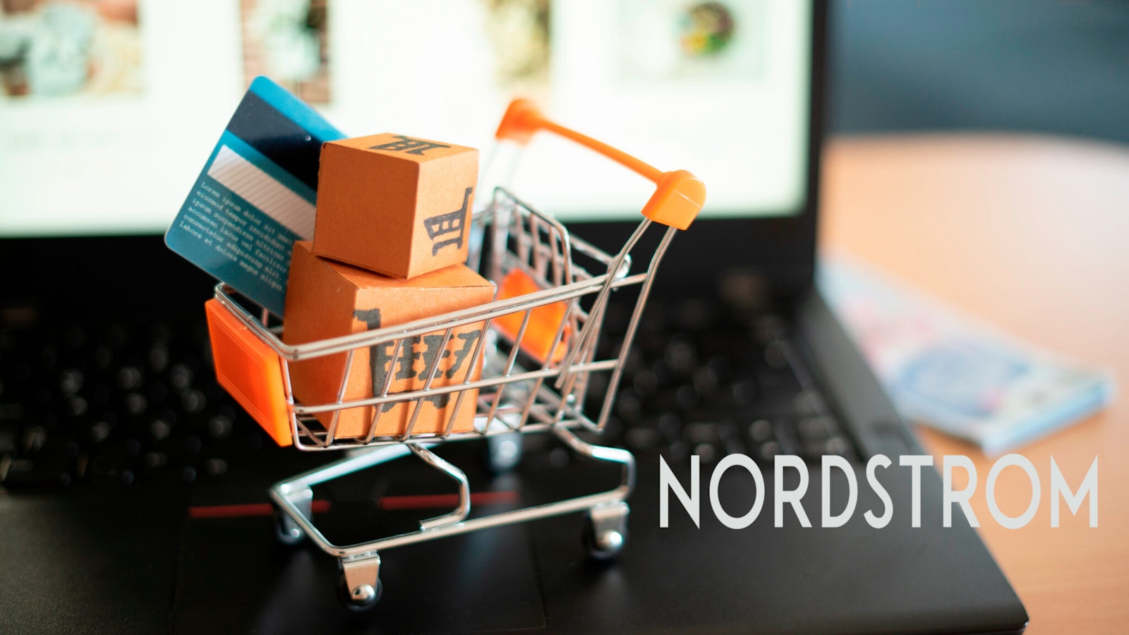 Graphic featuring a shopping cart with packages on a laptop keyboard and the Nordstrom logo, symbolizing connected retail systems and automated order workflows.