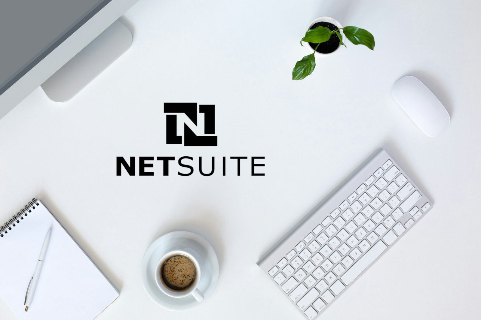 Graphic featuring a workspace with coffee, a keyboard, and the NetSuite logo, symbolizing API development, documentation, and integration planning.