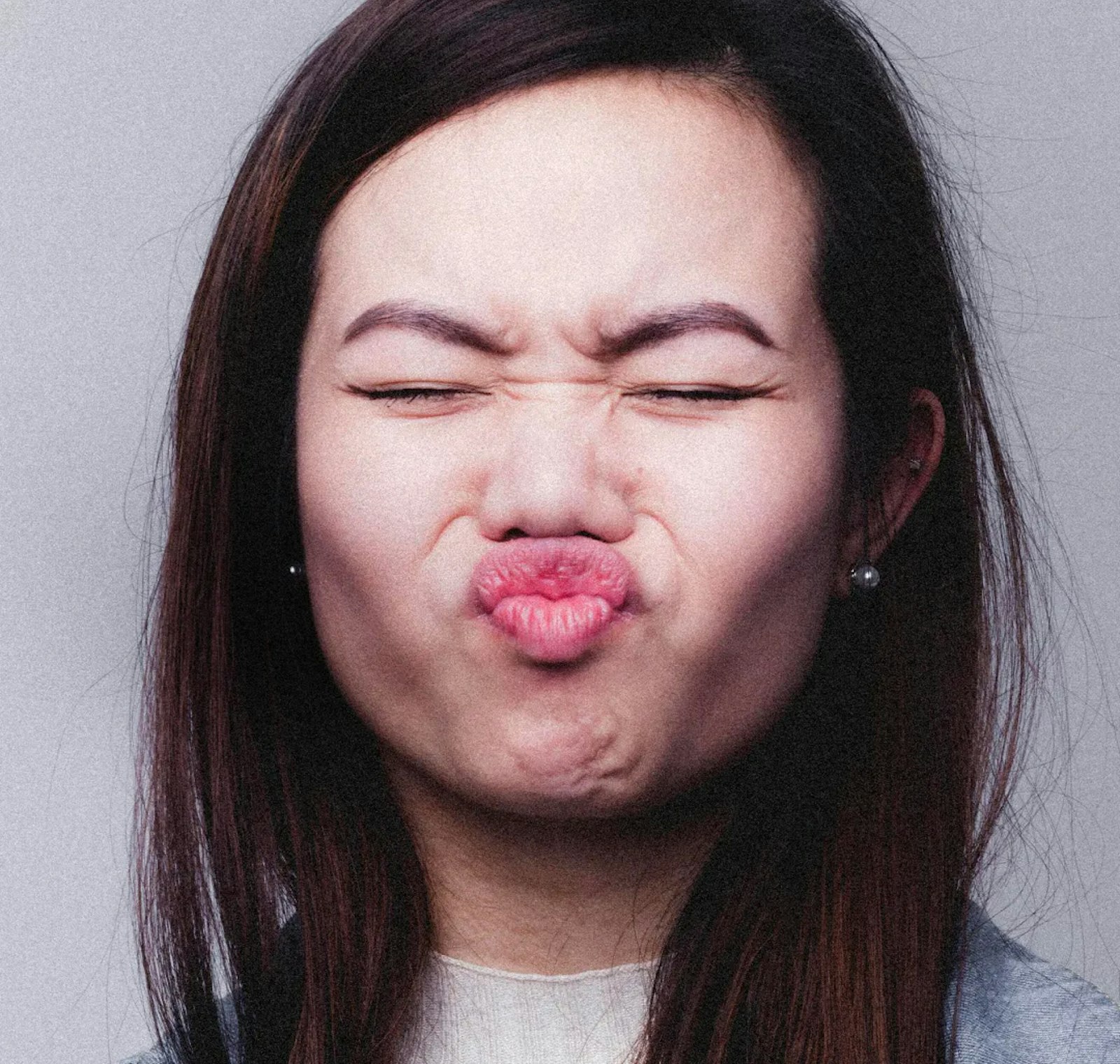 Image of a woman making a scrunched-up expression