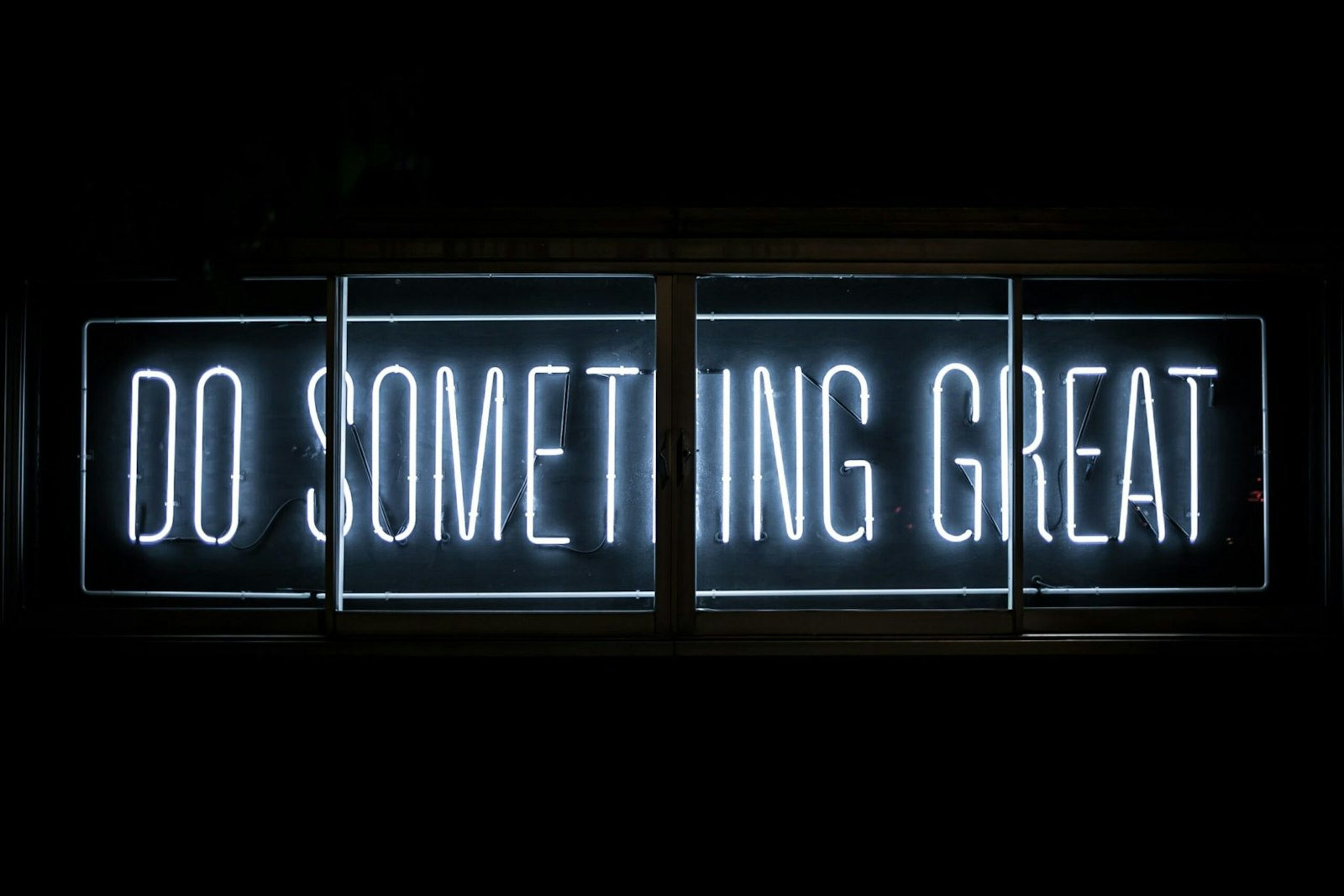 Glowing sign displaying the words "Do Something Great," representing the importance of creating high-quality content for SEO success.