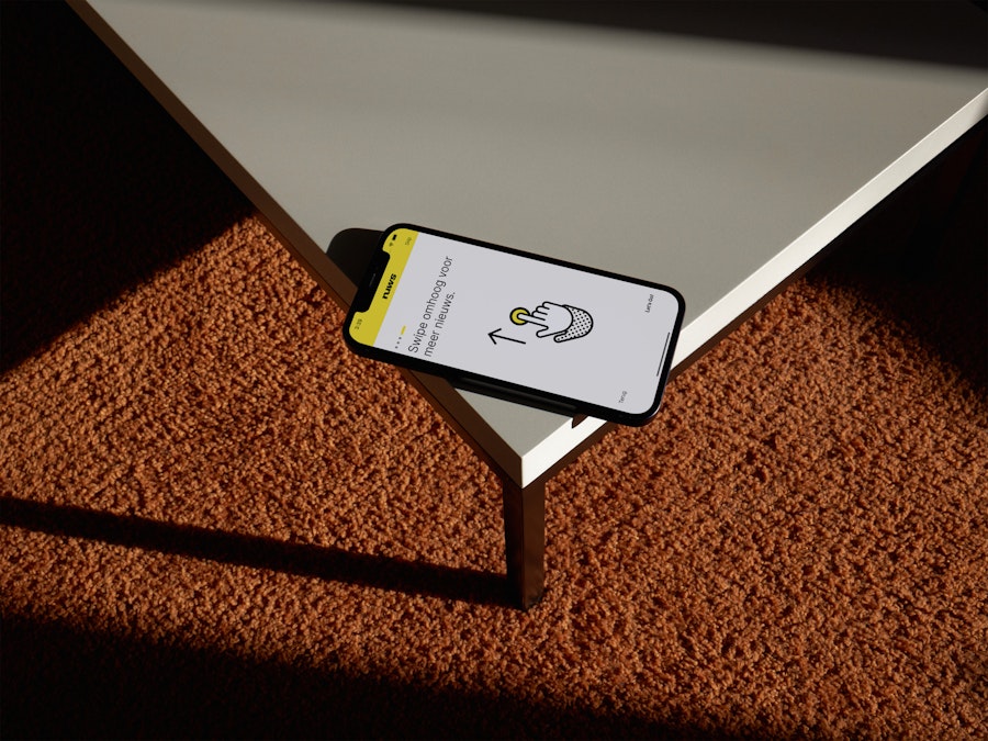 iPhone with the Nuws application open lying on a table