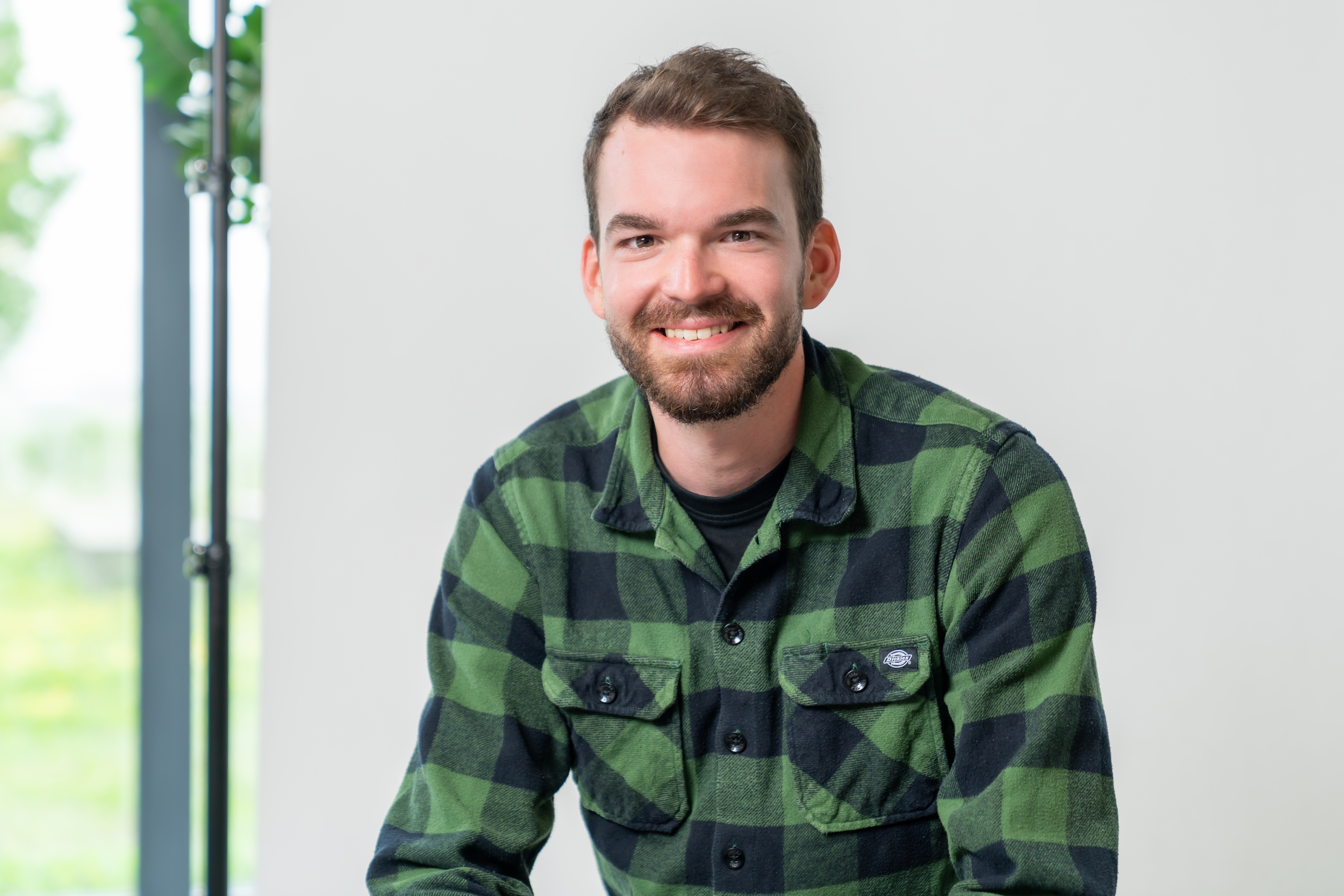 Portrait photo of a man in a green shirt.