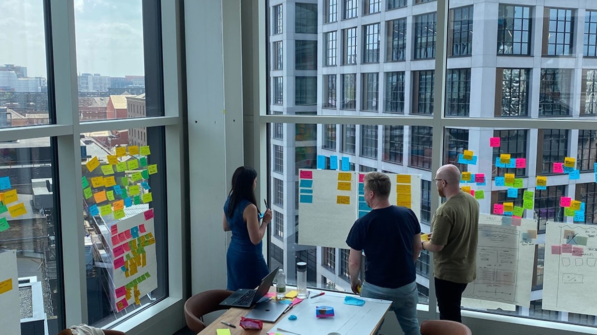People stood with postits on a window
