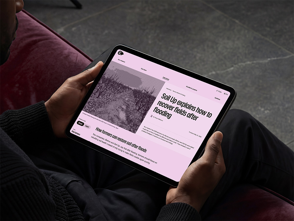 Person holding a tablet showing one of the articles of ClimateAdaptation.life