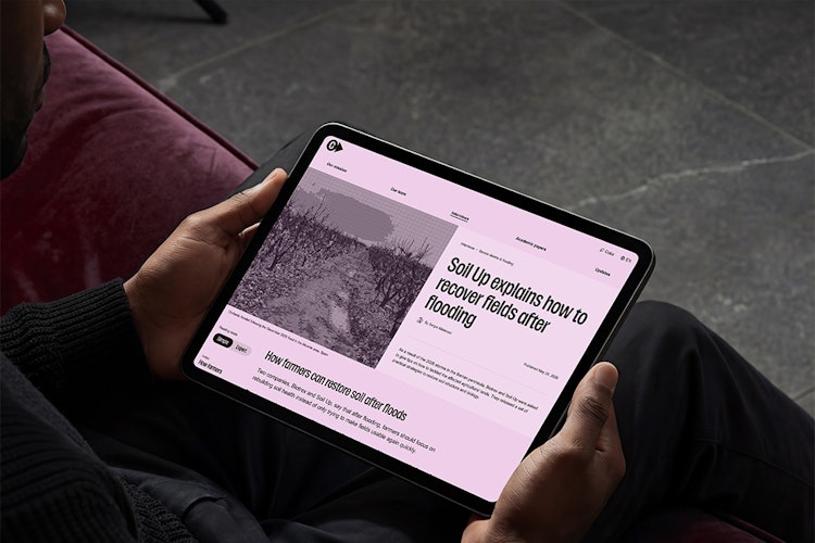 ClimateAdaptation.life on tablet Person holding a tablet showing one of the articles of ClimateAdaptation.life