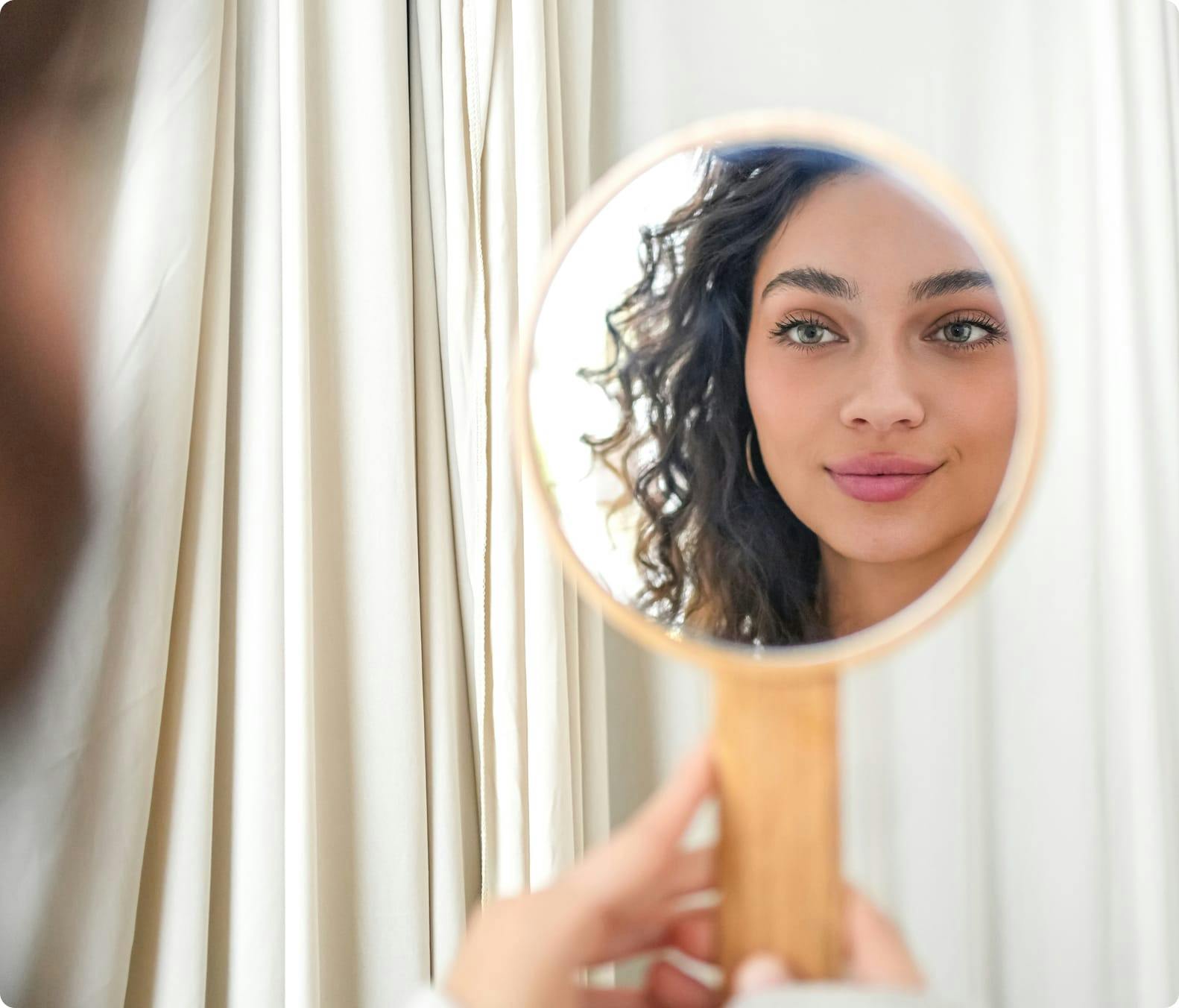 woman looking in mirror