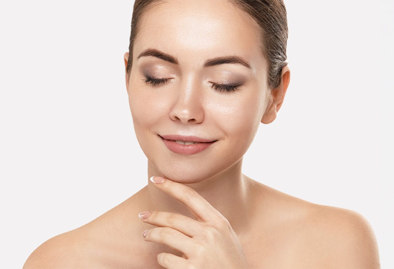 woman looking down touching her chin