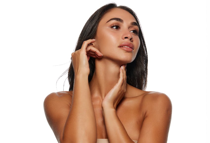 woman touching her neck