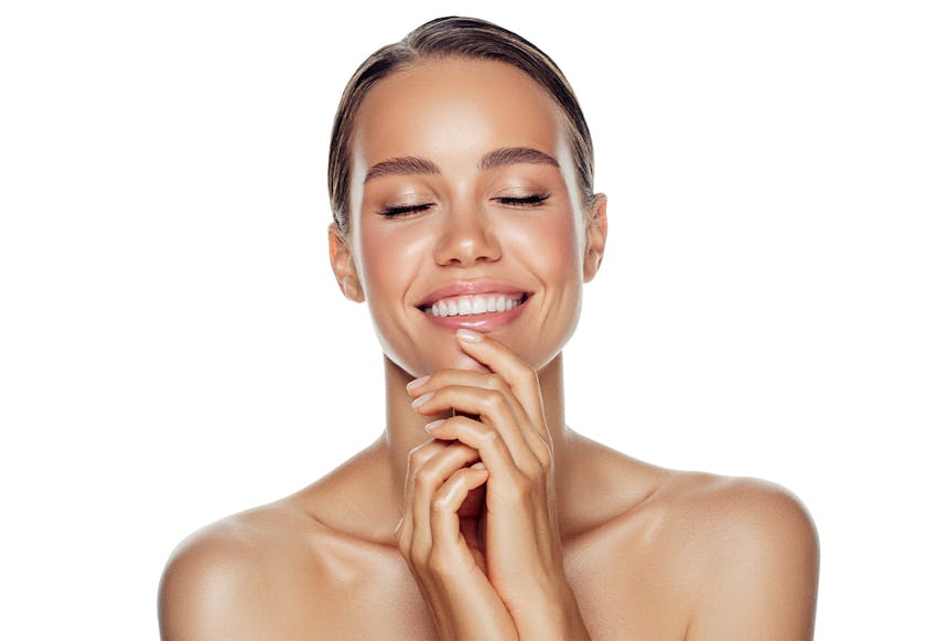 women smiling and holding chin