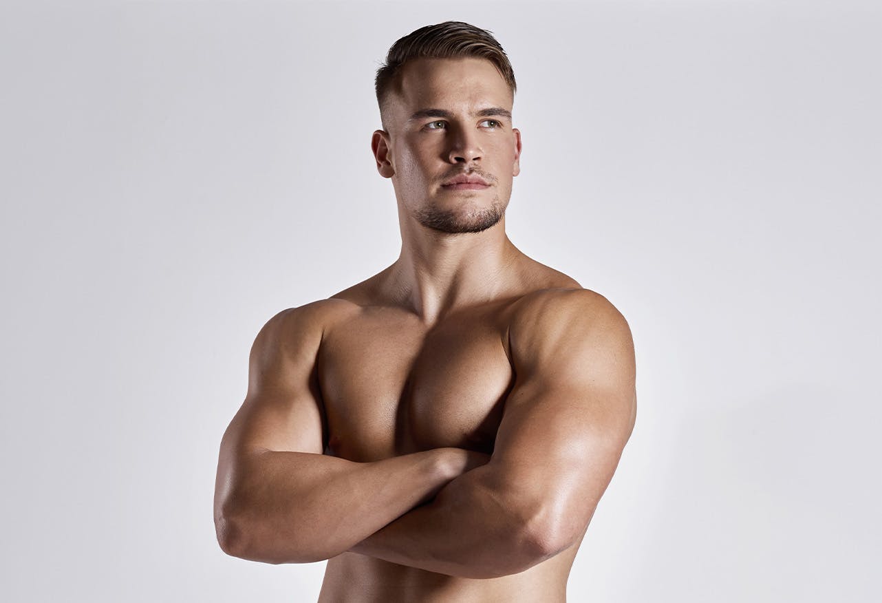 man looking to side with arms crossed