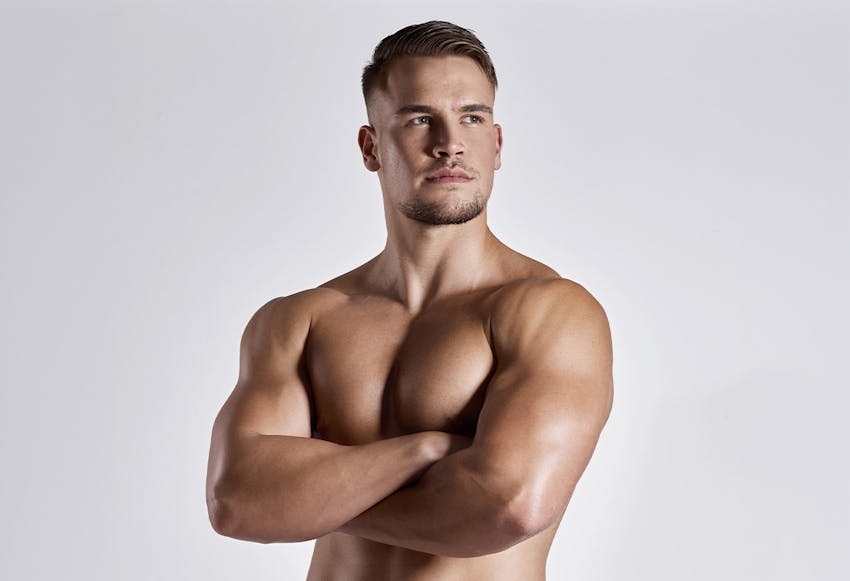 man looking to side with arms crossed