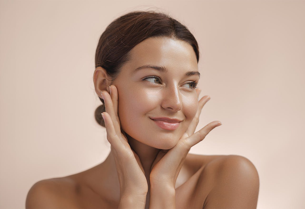 women smirking with hands on face