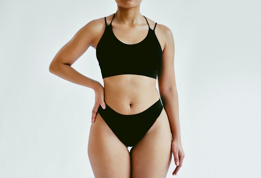 women standing with hand on hip