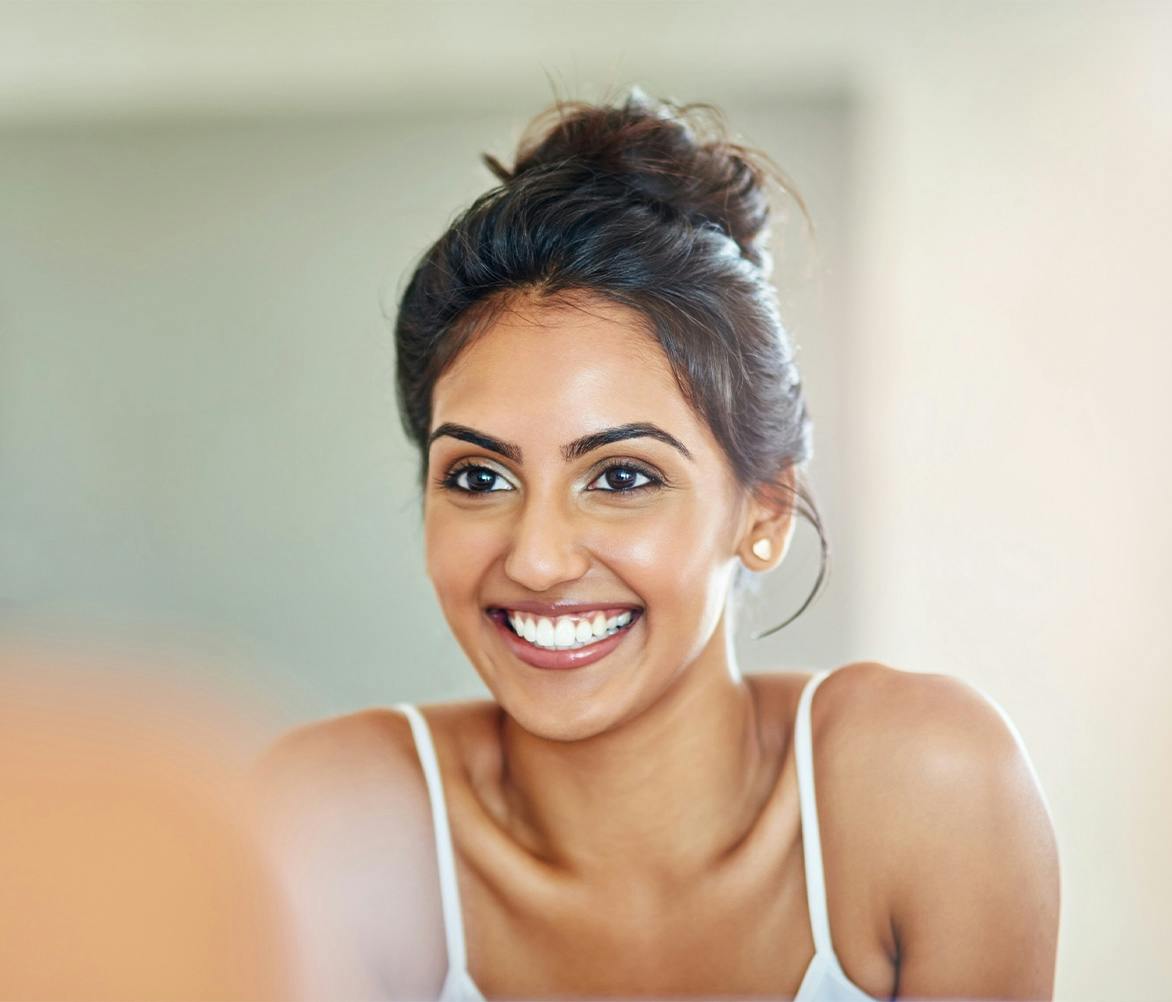 women smiling in mirror
